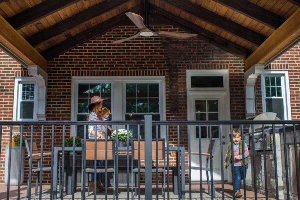 Covered Deck Wood Ceiling Black Railing Brick House