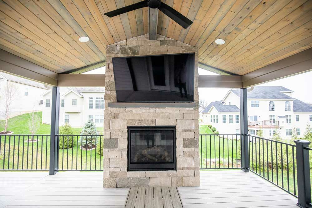 California Custom Decks custom deck with stone fireplace in Deckorators Voyage decking in Tundra color