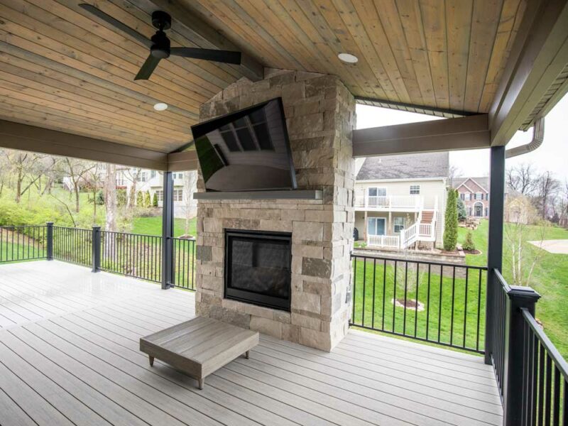 California Custom Decks custom deck with stone fireplace in Deckorators Voyage decking in Tundra color