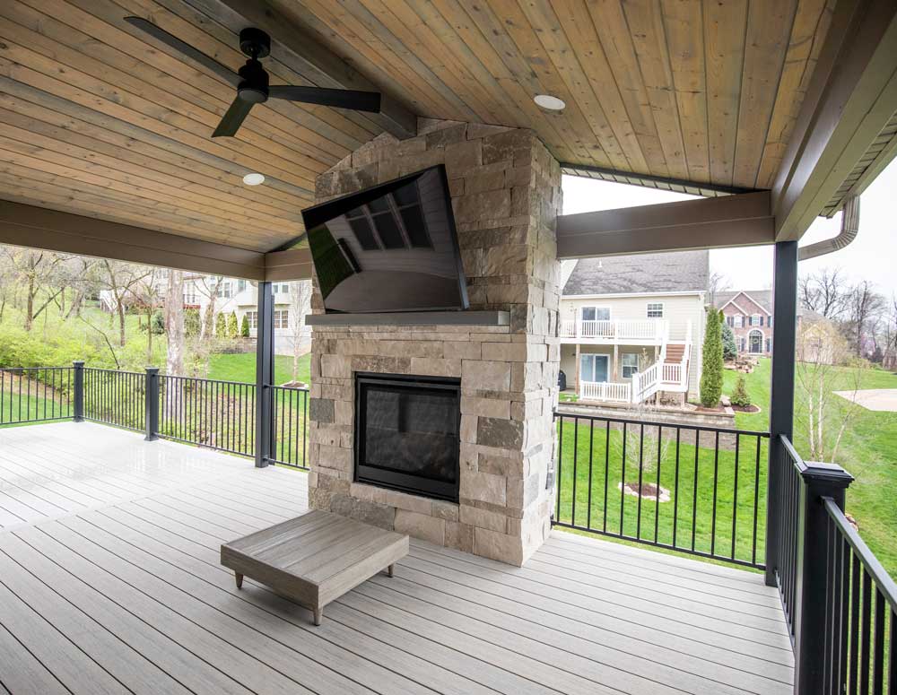 California Custom Decks custom deck with stone fireplace in Deckorators Voyage decking in Tundra color