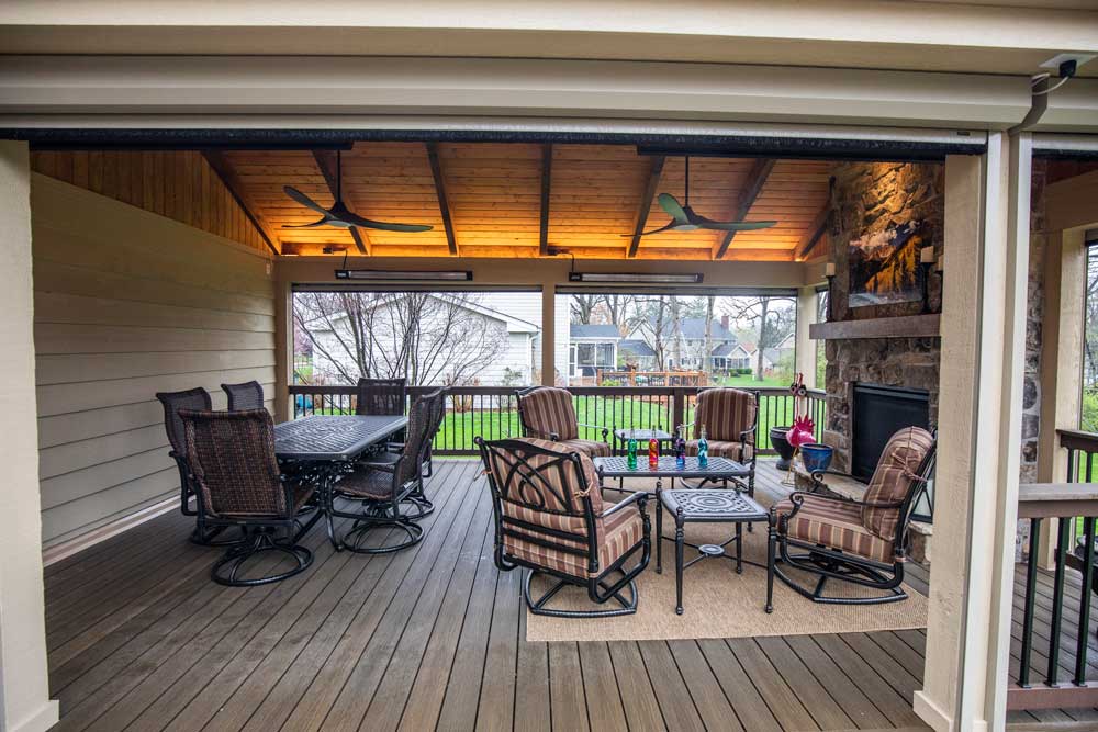 California Custom Decks retractable screen room with open deck and fireplace
