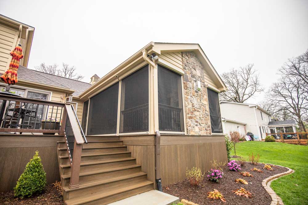 California Custom Decks retractable screen room with open deck and fireplace
