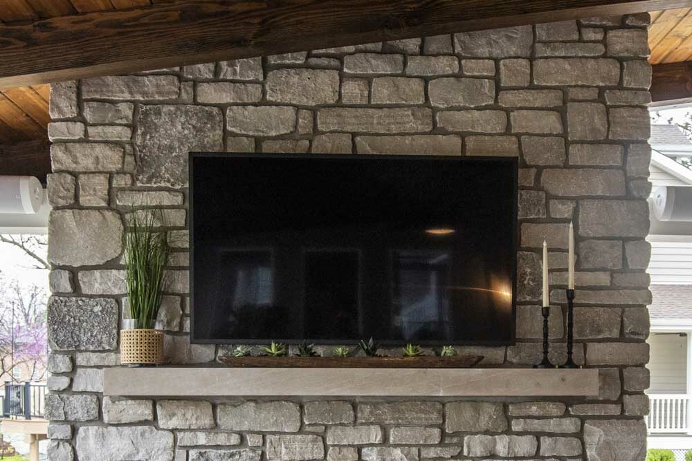 Outdoor fireplaces design - television with concrete mantel