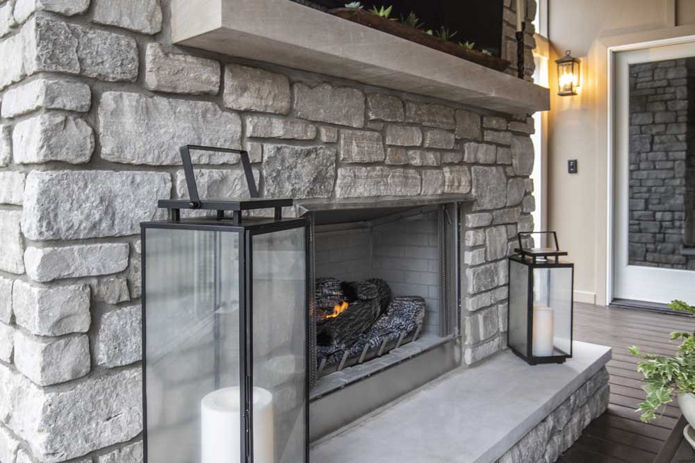 Outdoor fireplaces design - stone fireplace with concrete mantel