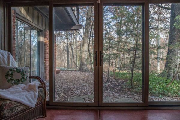 Interior of a Four Season Room with wood sliding doors in Huntleigh, MO