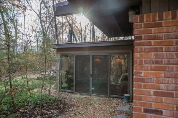 Exterior of a Four Season Room with wood sliding doors in Huntleigh, MO